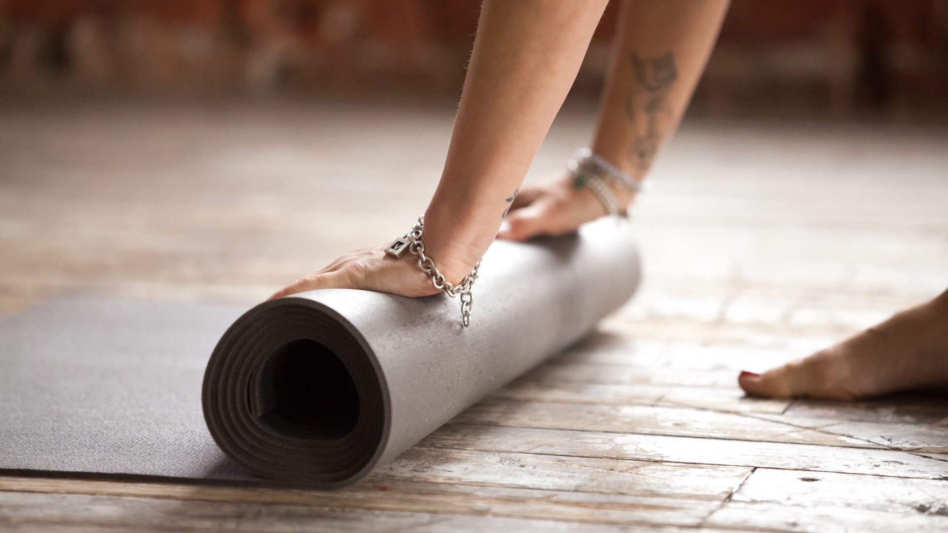hands-rolling-fitness-mat-concept-healthy-lifestyle